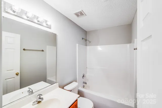 an empty room with wooden floor and window