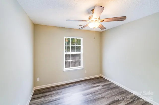 a view of a hallway with wooden floor and entryway