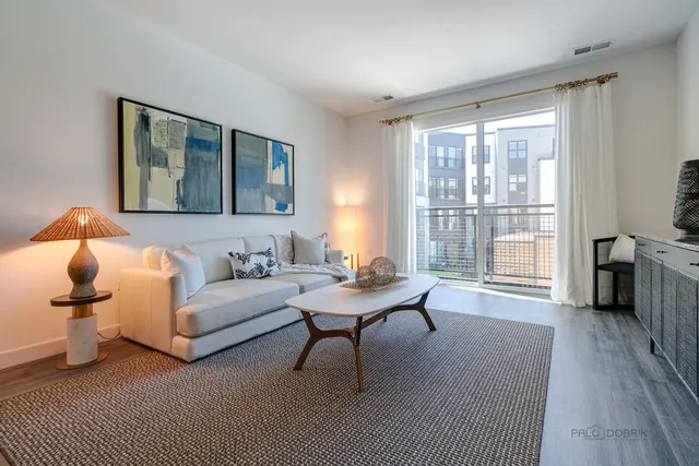 a living room with furniture and kitchen view