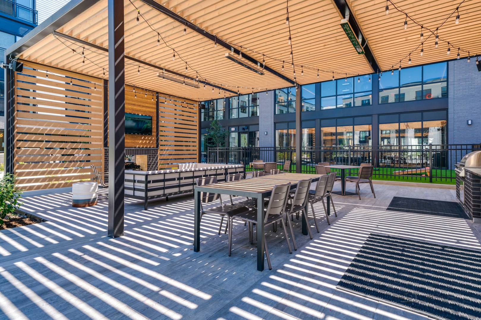 750 Hawthorn Row, Unit 1115 Vernon Hills, IL 60061 - Photo 22 of 24 a view of a patio with table and chairs with wooden floor and fence
