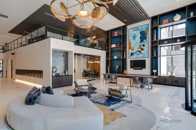 a living room with furniture a window and flat screen tv