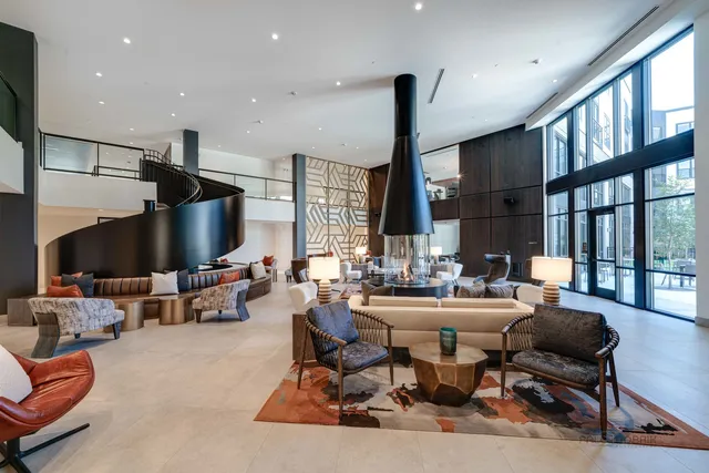 a living room with furniture large window and flat screen tv