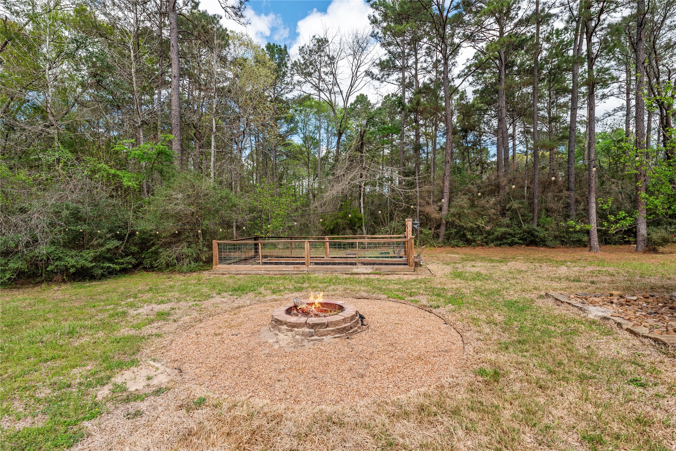 12062 Ike White Road Conroe, TX 77303 - Photo 31 of 37 Fire pit and fenced-in garden areas.