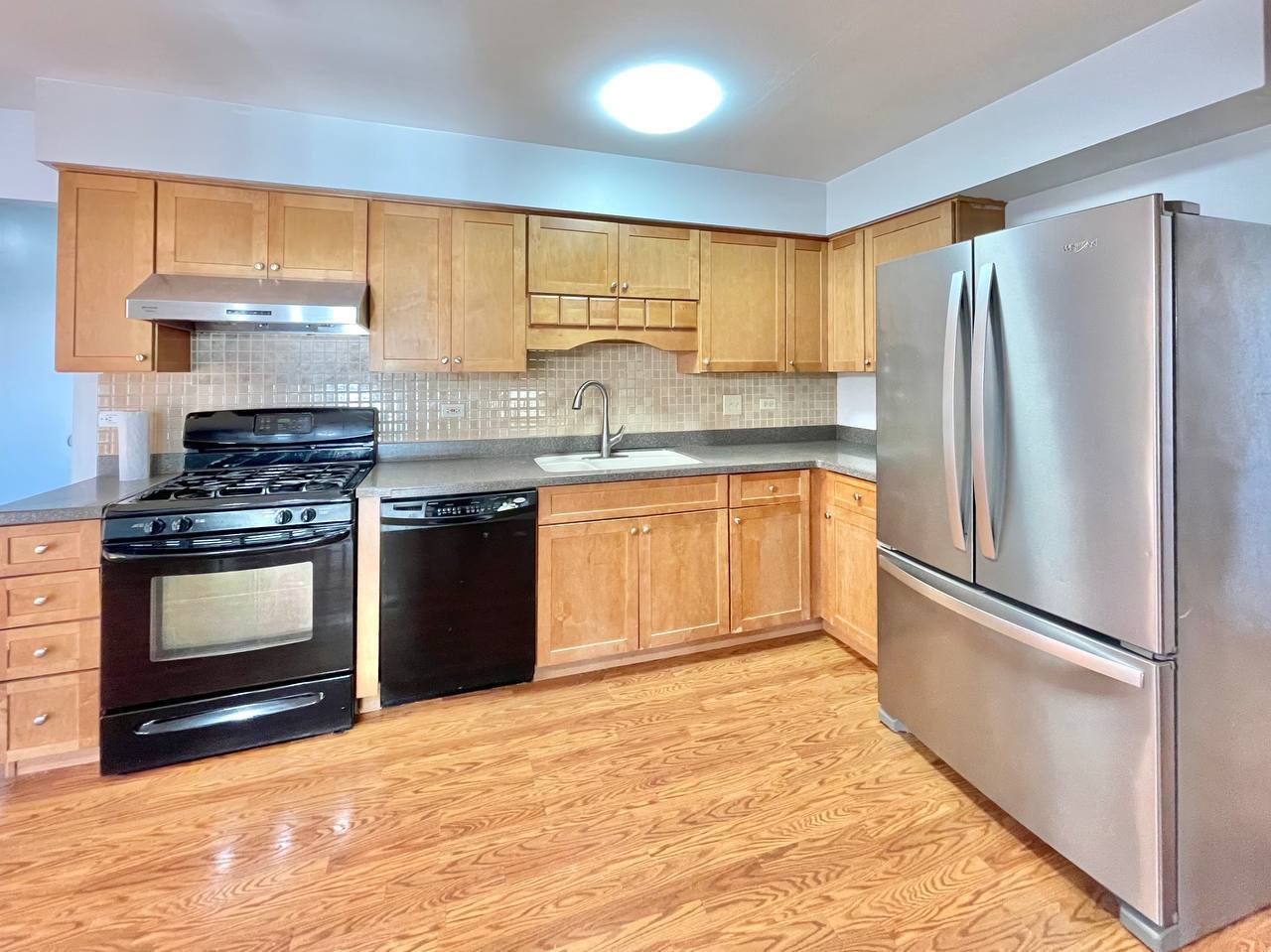 1689 Apple Valley Road Bolingbrook, IL 60490 - Photo 4 of 28 a kitchen with granite countertop a refrigerator stove and sink