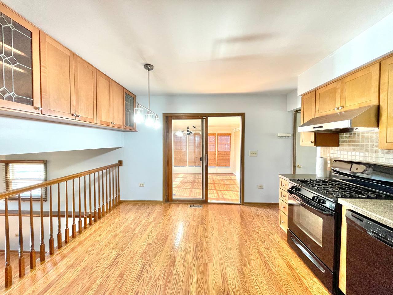 1689 Apple Valley Road Bolingbrook, IL 60490 - Photo 6 of 28 a view of a kitchen with wooden floor and electronic appliances
