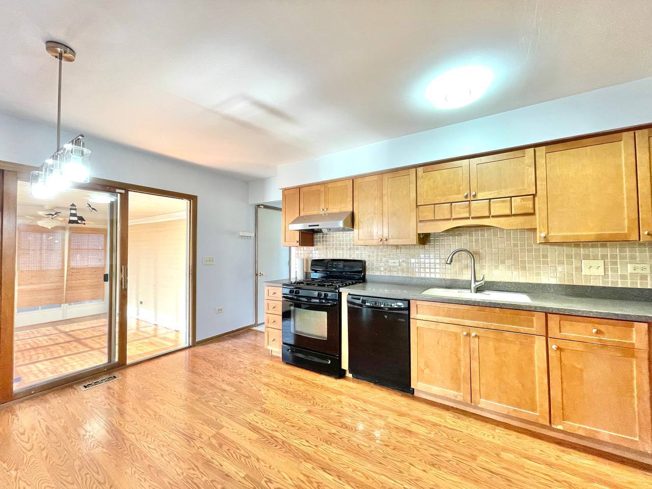 1689 Apple Valley Road Bolingbrook, IL 60490 - Photo 7 of 28 a kitchen with stainless steel appliances granite countertop a stove and a sink