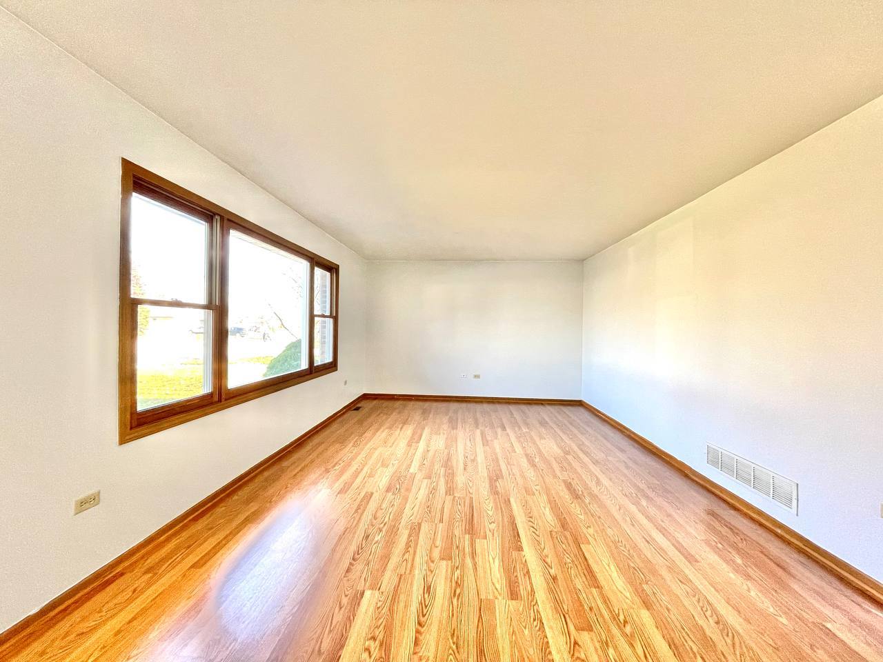 1689 Apple Valley Road Bolingbrook, IL 60490 - Photo 9 of 28 wooden floor in an empty room with a window