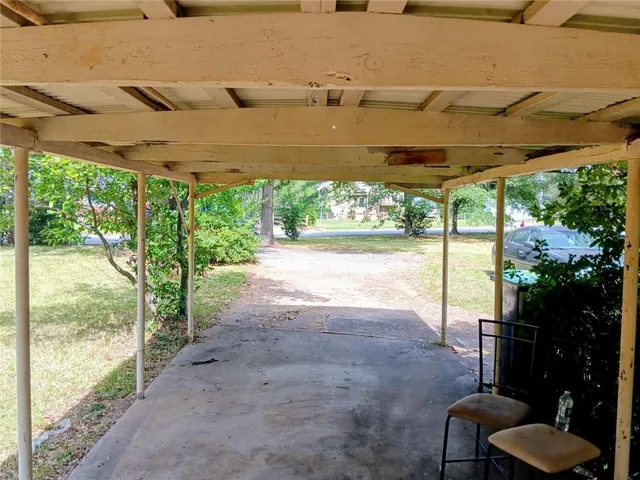 a view of a porch with chairs and backyard