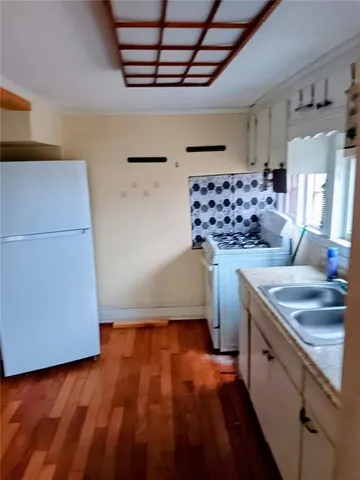 a kitchen with a refrigerator and a stove