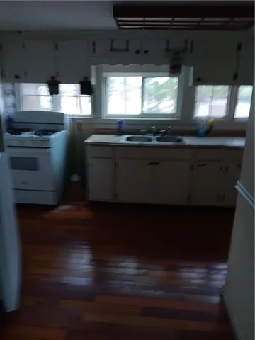 a kitchen with stainless steel appliances a stove and a microwave oven