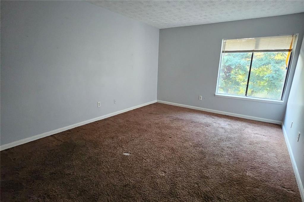 3575 Oakvale Road, Unit 420 Decatur, GA 30034 - Photo 11 of 13 an empty room with a window
