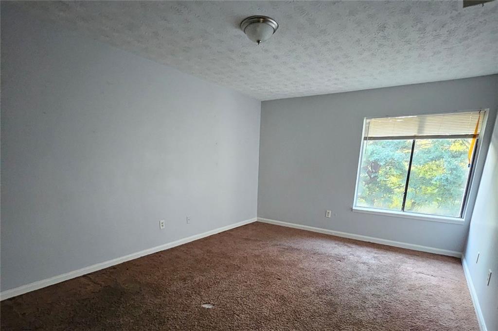 3575 Oakvale Road, Unit 420 Decatur, GA 30034 - Photo 7 of 13 an empty room with windows