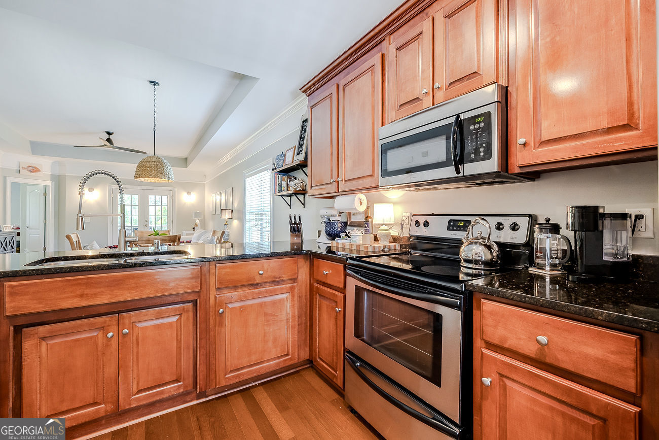 7272 Shellman Bluff Road Northeast, Unit 18 Townsend, GA 31331 - Photo 13 of 31 a kitchen with stainless steel appliances granite countertop a stove and cabinets
