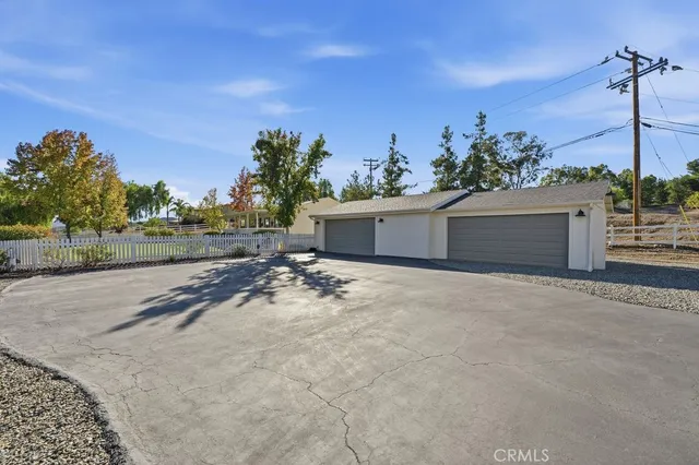 a view of a house with a yard and a garage