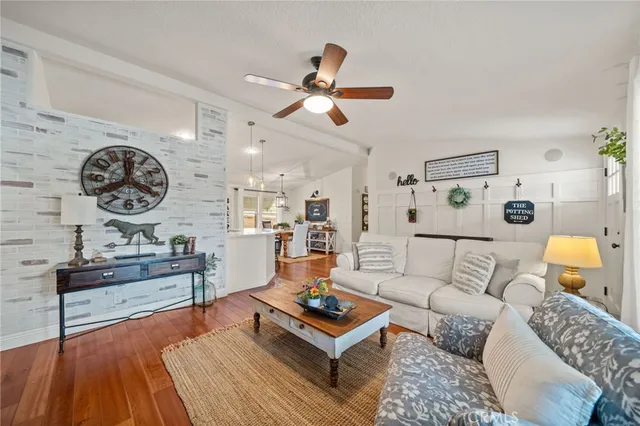 a living room with furniture ceiling fan and a window