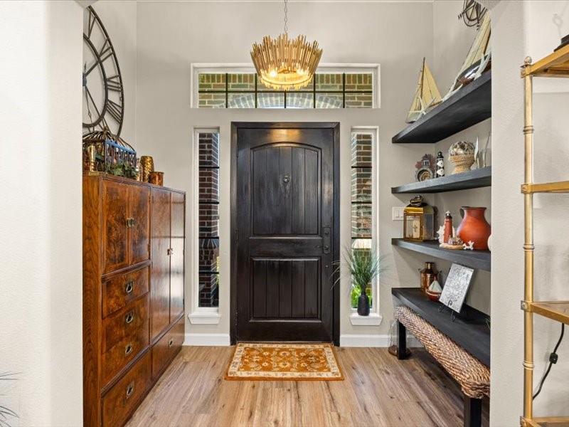 3510 Fountain Way Granbury, TX 76049 - Photo 2 of 27 Entryway with light wood-style flooring and a chandelier