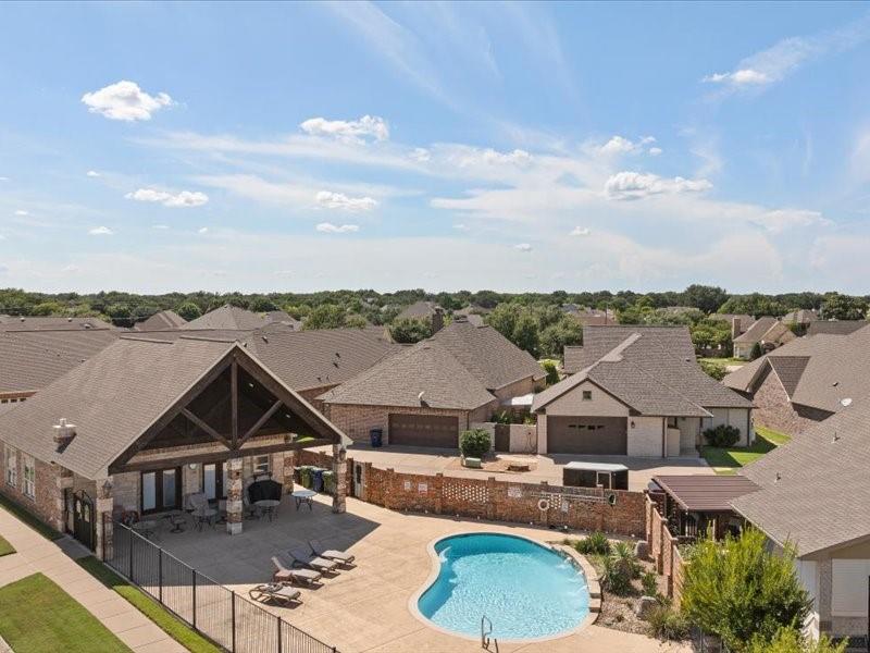 3510 Fountain Way Granbury, TX 76049 - Photo 25 of 27 Community pool featuring a residential view and a patio area