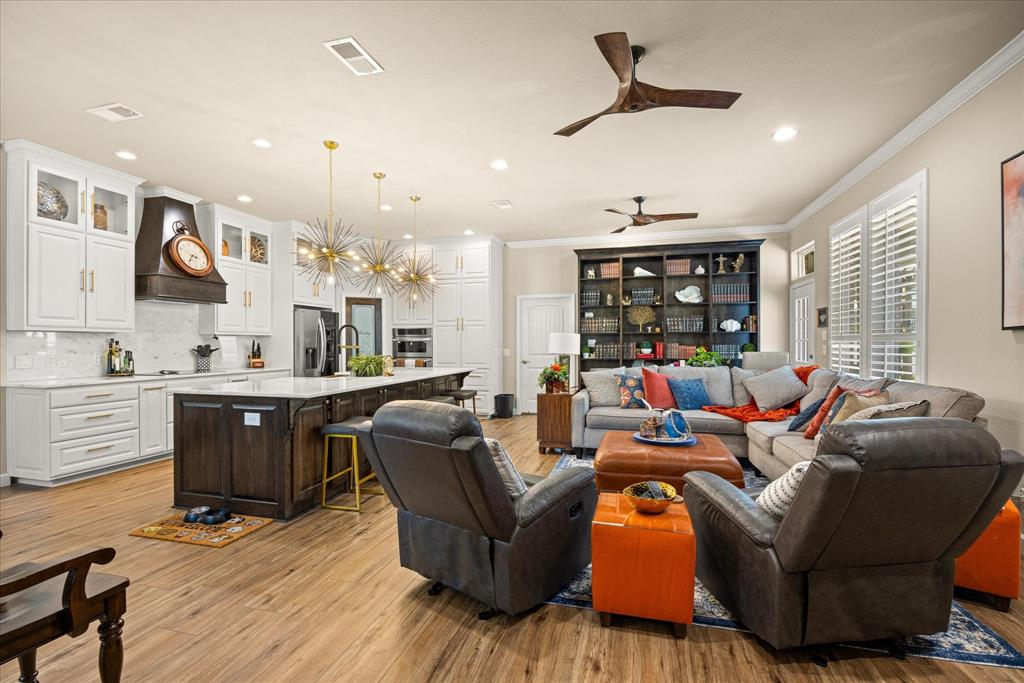 3510 Fountain Way Granbury, TX 76049 - Photo 4 of 27 Living area featuring a chandelier, light wood-style floors, ornamental molding, a ceiling fan, and recessed lighting