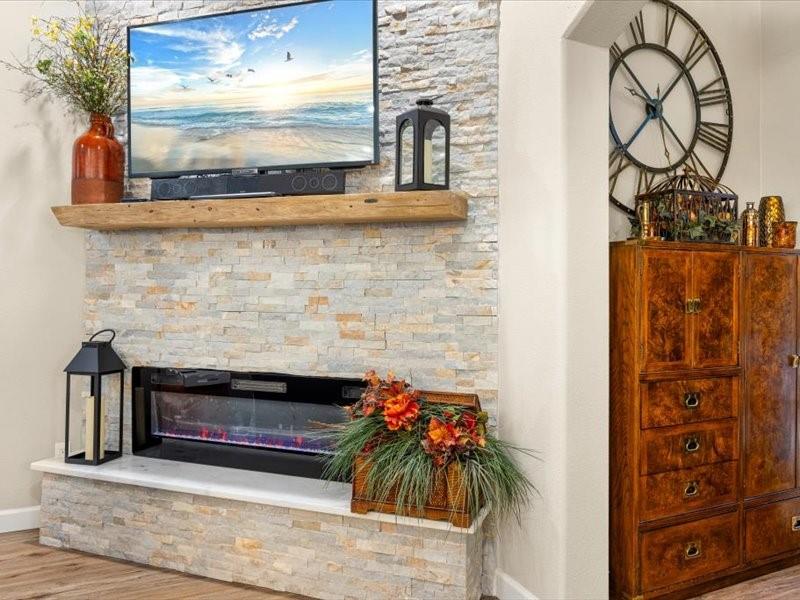 3510 Fountain Way Granbury, TX 76049 - Photo 6 of 27 Detailed view of wood finished floors and a stone fireplace