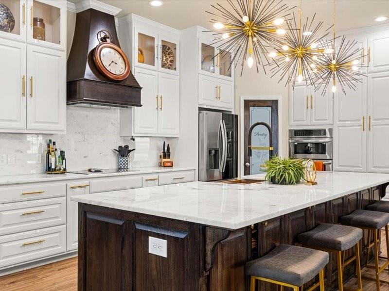 3510 Fountain Way Granbury, TX 76049 - Photo 7 of 27 Kitchen with white cabinets, dark brown cabinetry, a large island with sink, and recessed lighting