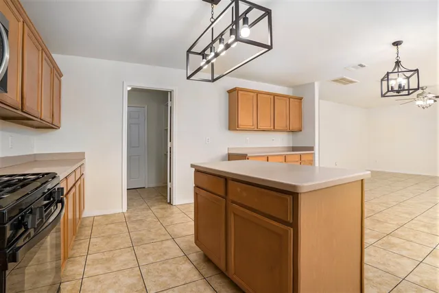 a kitchen with a sink cabinets and stainless steel appliances