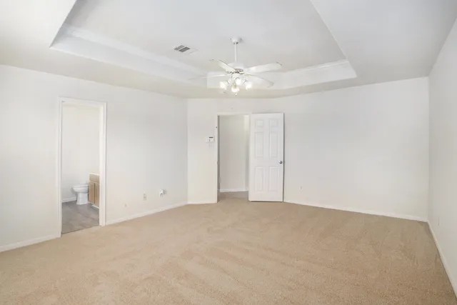 a view of an empty room with a ceiling fan