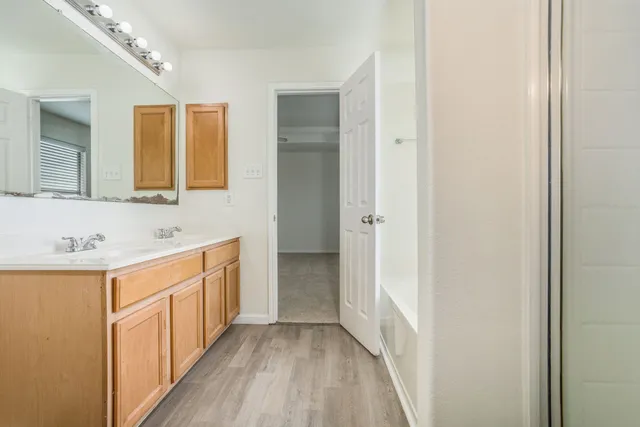 a bathroom with a sink a mirror and a shower