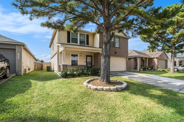 a front view of a house with a yard