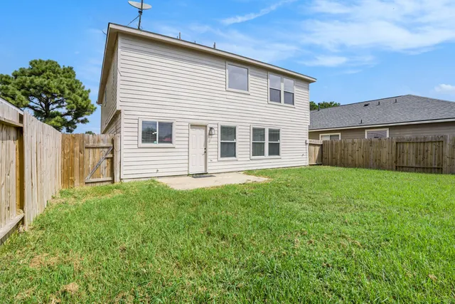 a view of a house with a backyard