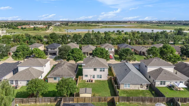 an aerial view of residential houses with outdoor space and ocean view