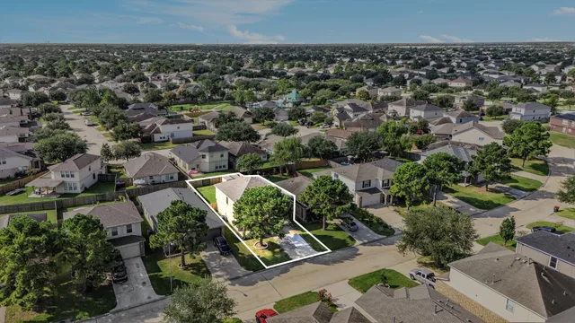 an aerial view of residential houses with outdoor space