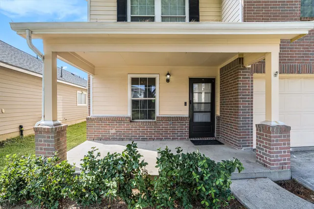 a view of front door of house with potted plant