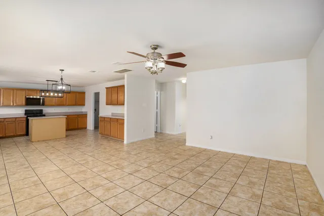a view of a kitchen with a sink and a chandelier fan