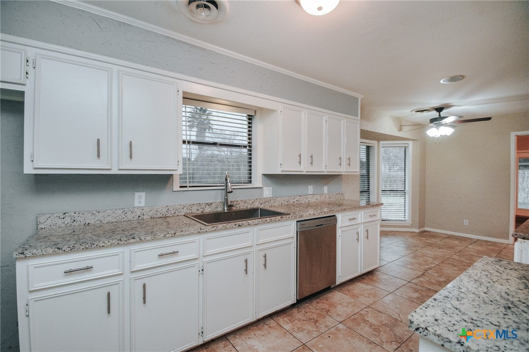 115 Santa Fe Victoria, TX 77904 - Photo 11 of 17 a kitchen with a sink dishwasher a stove and cabinets