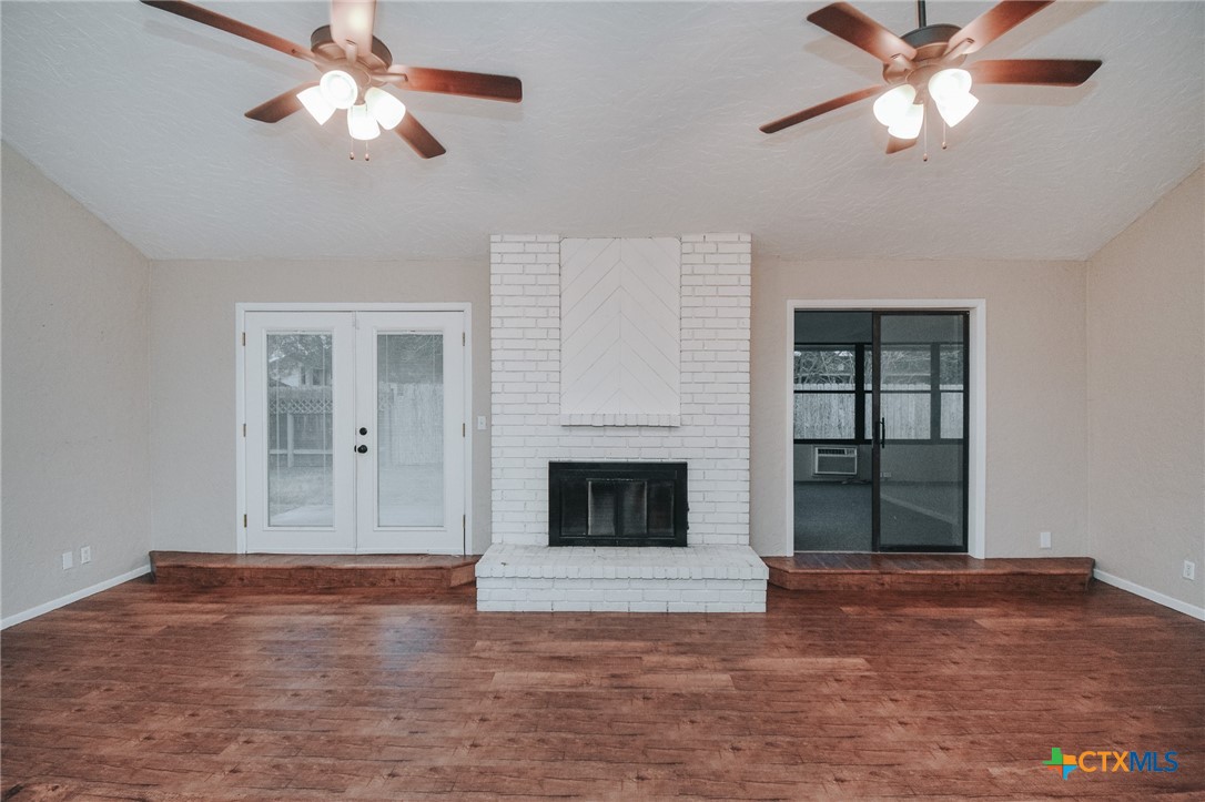 115 Santa Fe Victoria, TX 77904 - Photo 6 of 17 a view of a livingroom with a ceiling fan a fireplace