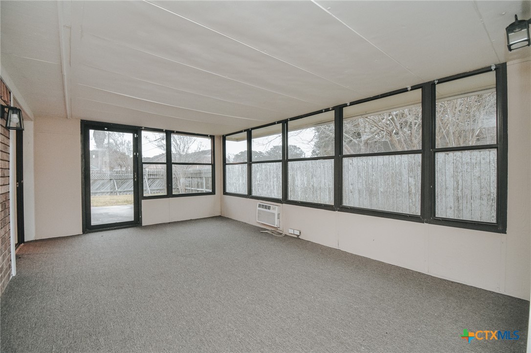 115 Santa Fe Victoria, TX 77904 - Photo 7 of 17 wooden floor in an empty room with a window