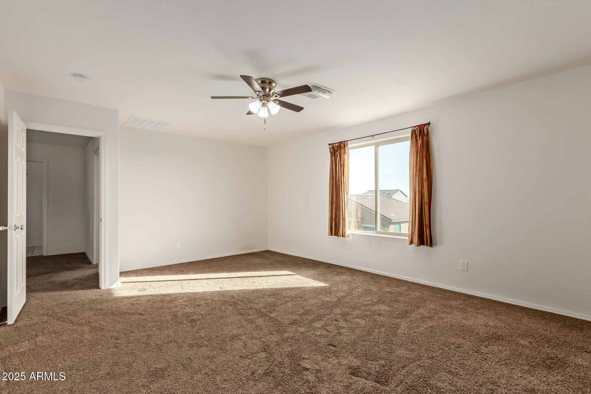 11603 West Calavar Road El Mirage, AZ 85335 - Photo 15 of 38 a view of an empty room with a window