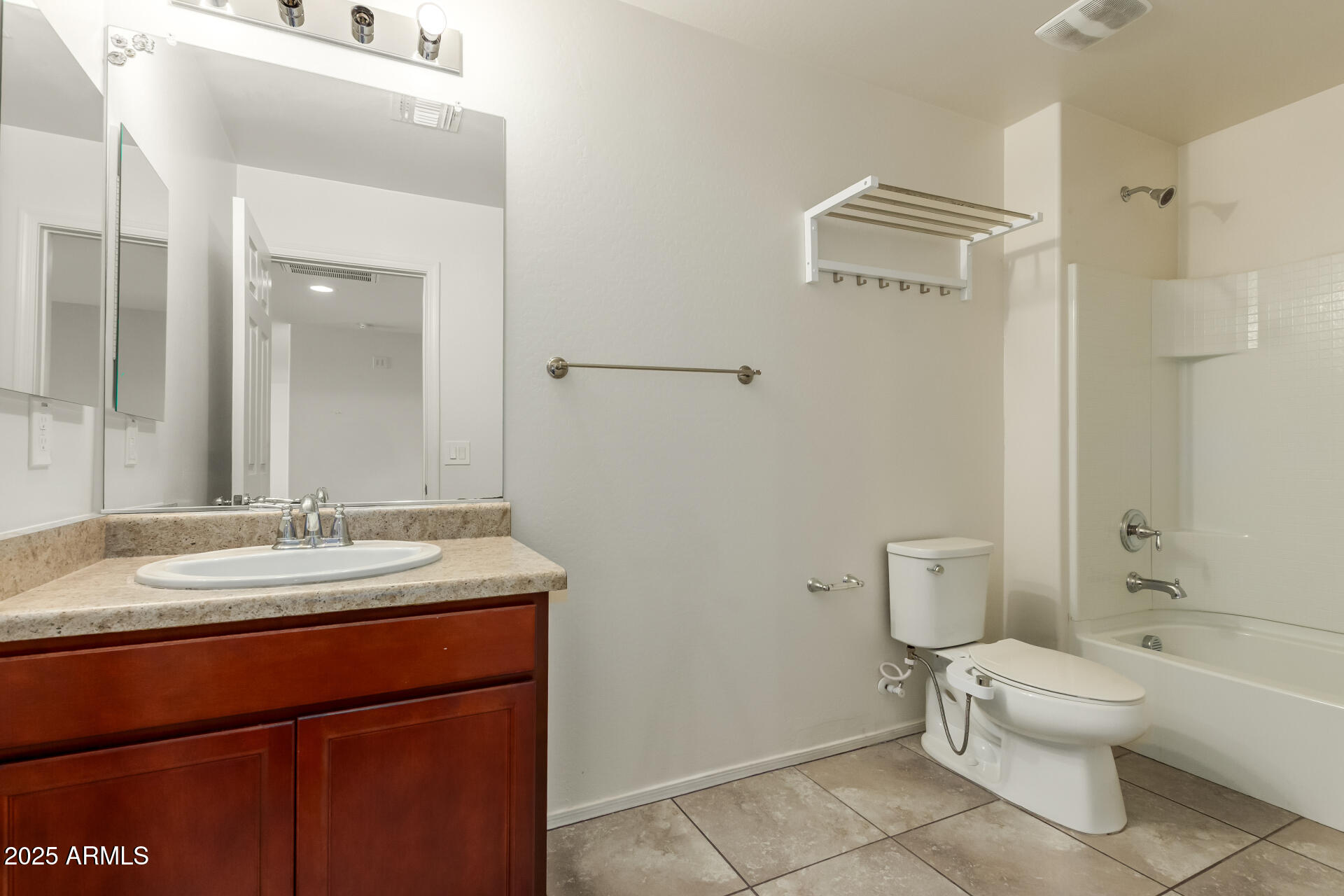 11603 West Calavar Road El Mirage, AZ 85335 - Photo 23 of 38 a bathroom with a granite countertop sink toilet and shower