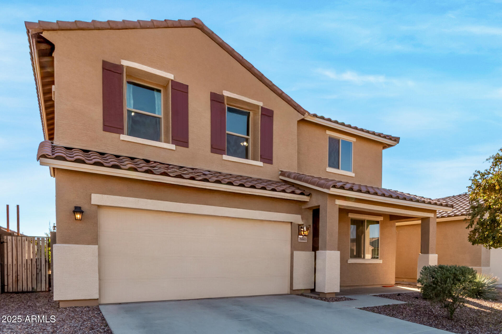 11603 West Calavar Road El Mirage, AZ 85335 - Photo 29 of 38 a front view of a house with a garage