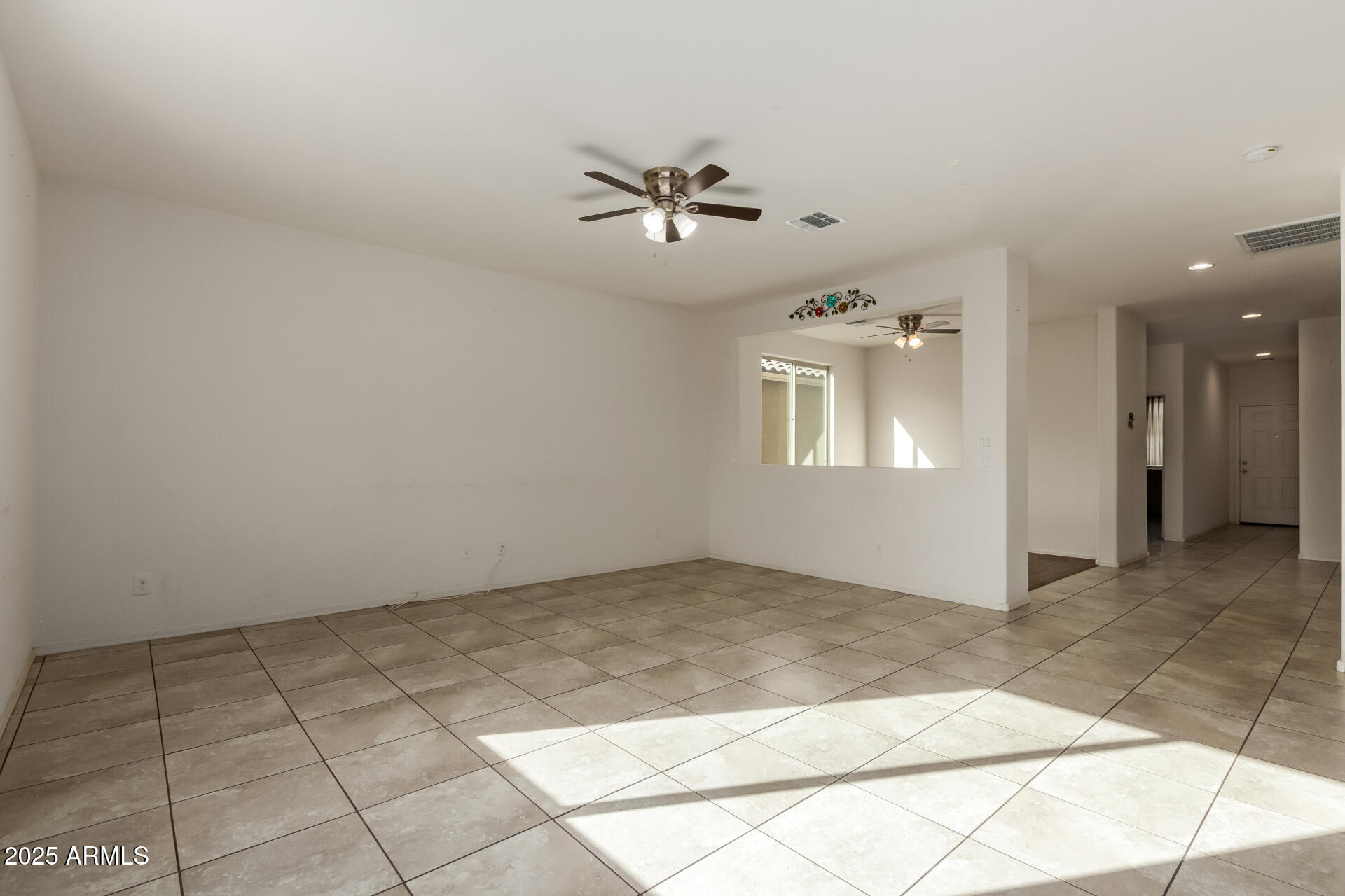 11603 West Calavar Road El Mirage, AZ 85335 - Photo 37 of 38 an empty room with windows and ceiling fan
