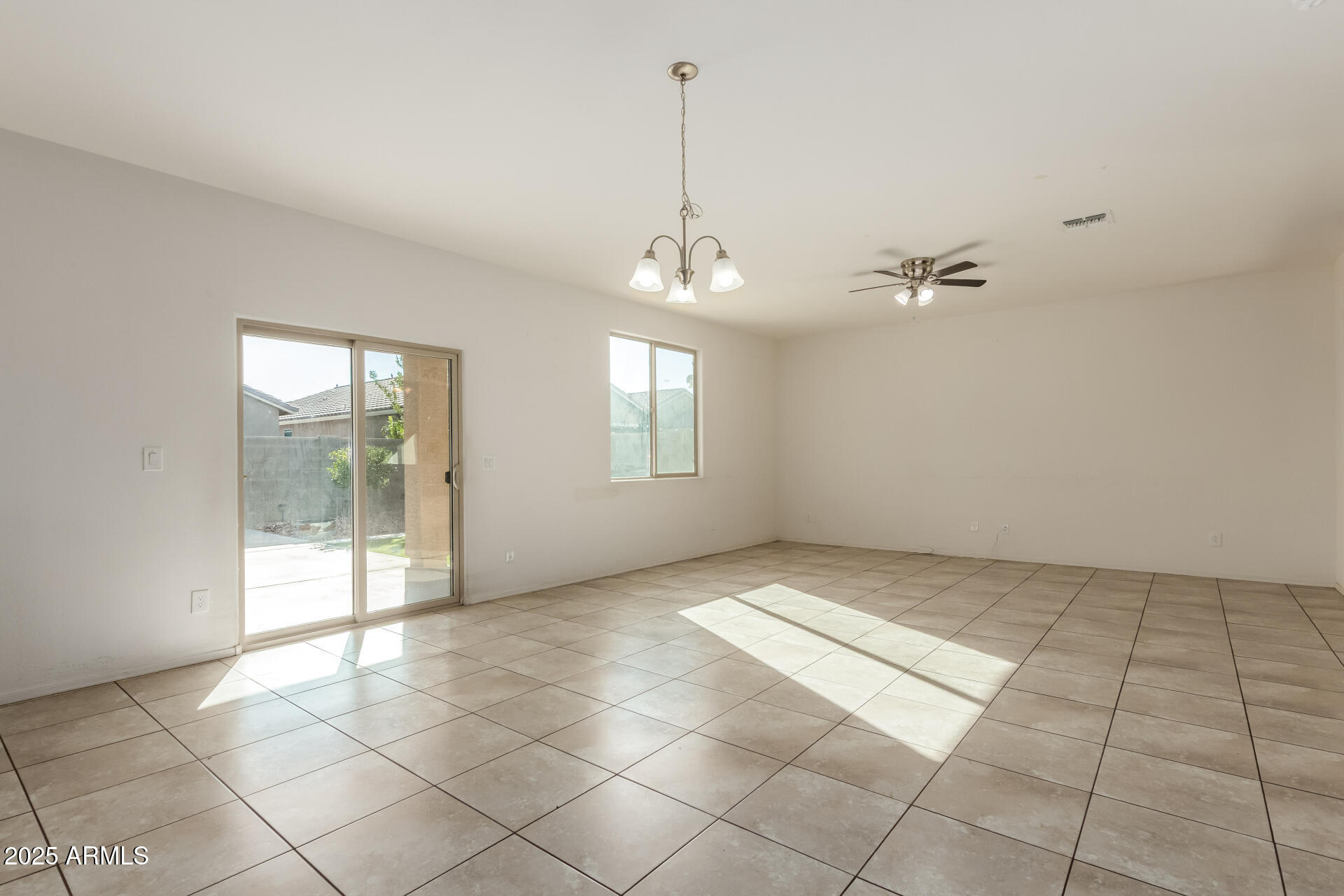 11603 West Calavar Road El Mirage, AZ 85335 - Photo 6 of 38 a view of an empty room with glass door