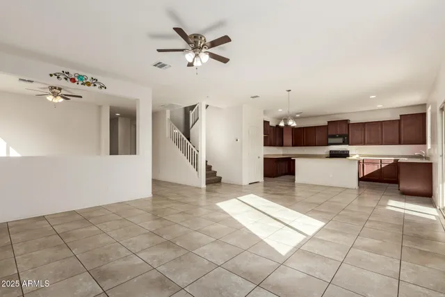 a view of a kitchen with furniture and an empty space