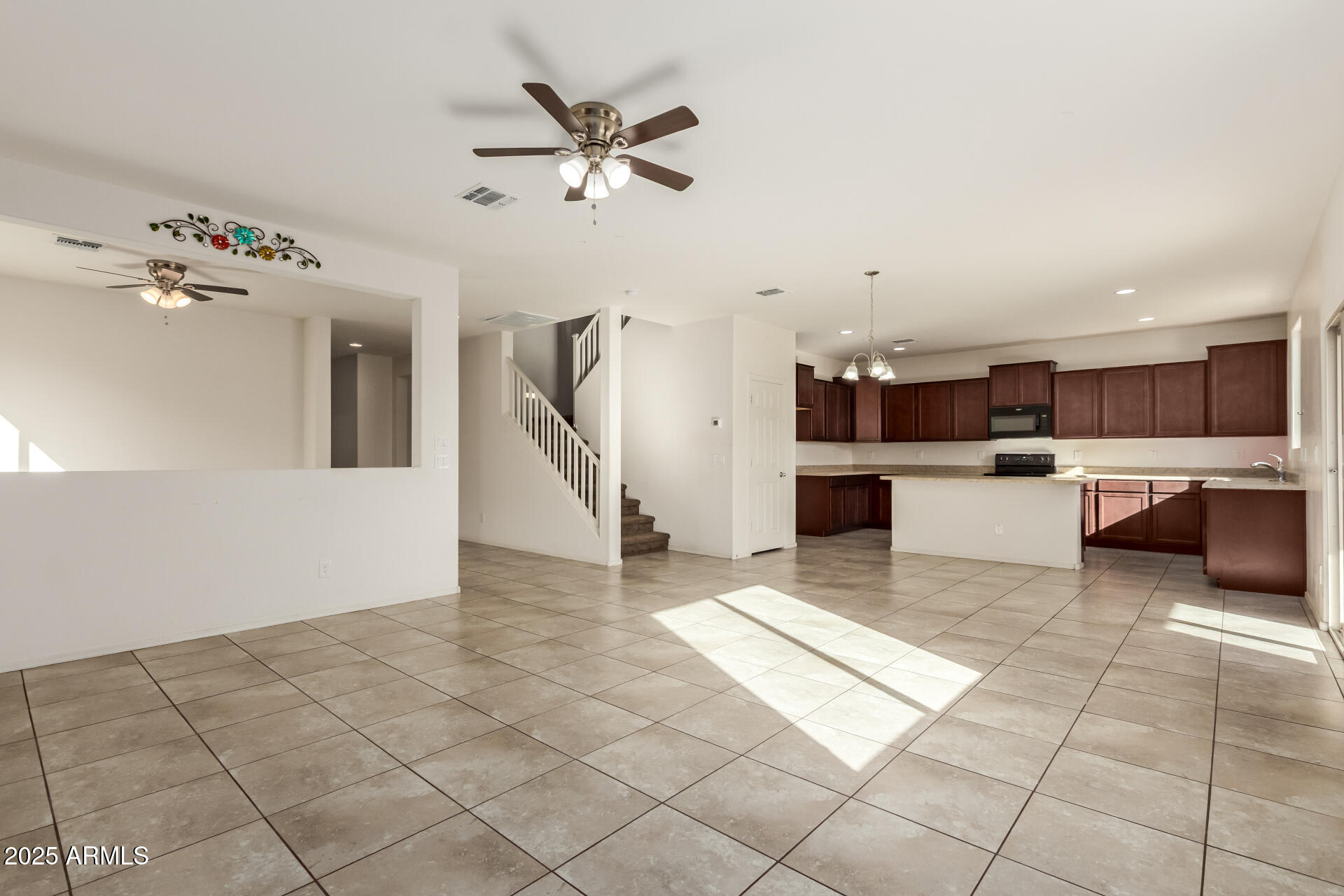 11603 West Calavar Road El Mirage, AZ 85335 - Photo 8 of 38 a view of a kitchen with furniture and an empty space