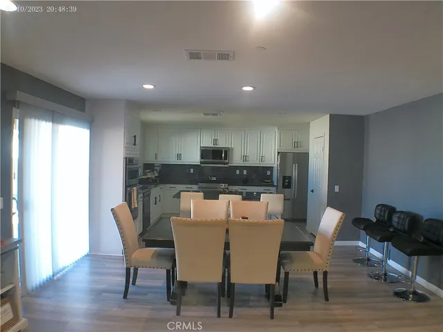 a kitchen with a sink white cabinets and stainless steel appliances