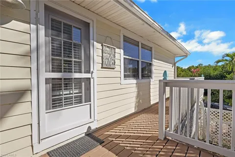 a view of a balcony with wooden floor and fence