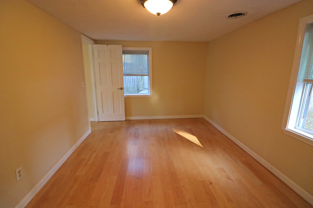 471 Plumtree Road Springfield, MA 01118 - Photo 5 of 15 wooden floor in an empty room with a window