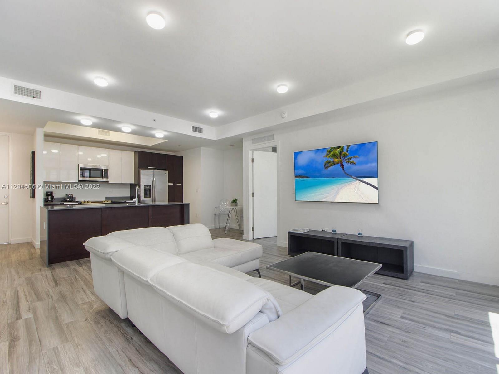 2955 Bird Avenue, Unit PHA Miami, FL 33133 - Photo 12 of 33 a living room with furniture and kitchen view