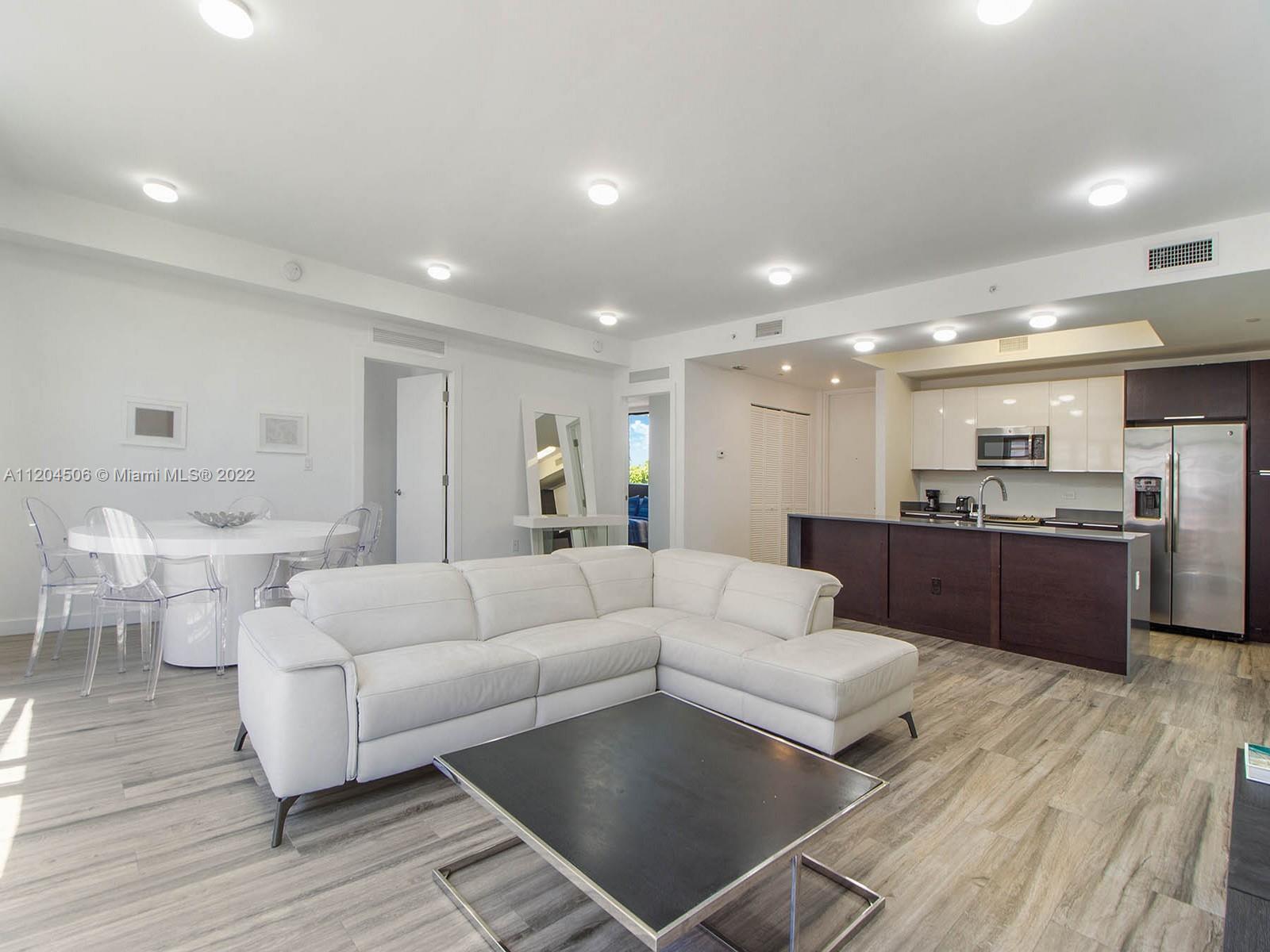 2955 Bird Avenue, Unit PHA Miami, FL 33133 - Photo 13 of 33 a living room with furniture and a wooden floor