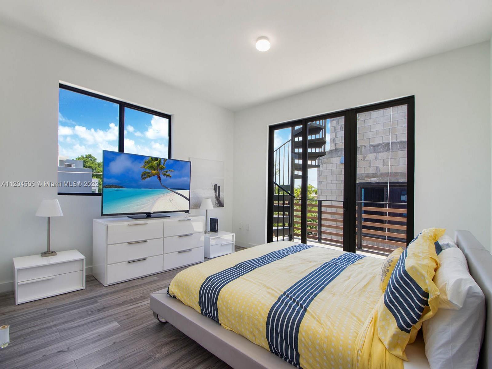 2955 Bird Avenue, Unit PHA Miami, FL 33133 - Photo 14 of 33 a bedroom with a bed and a window