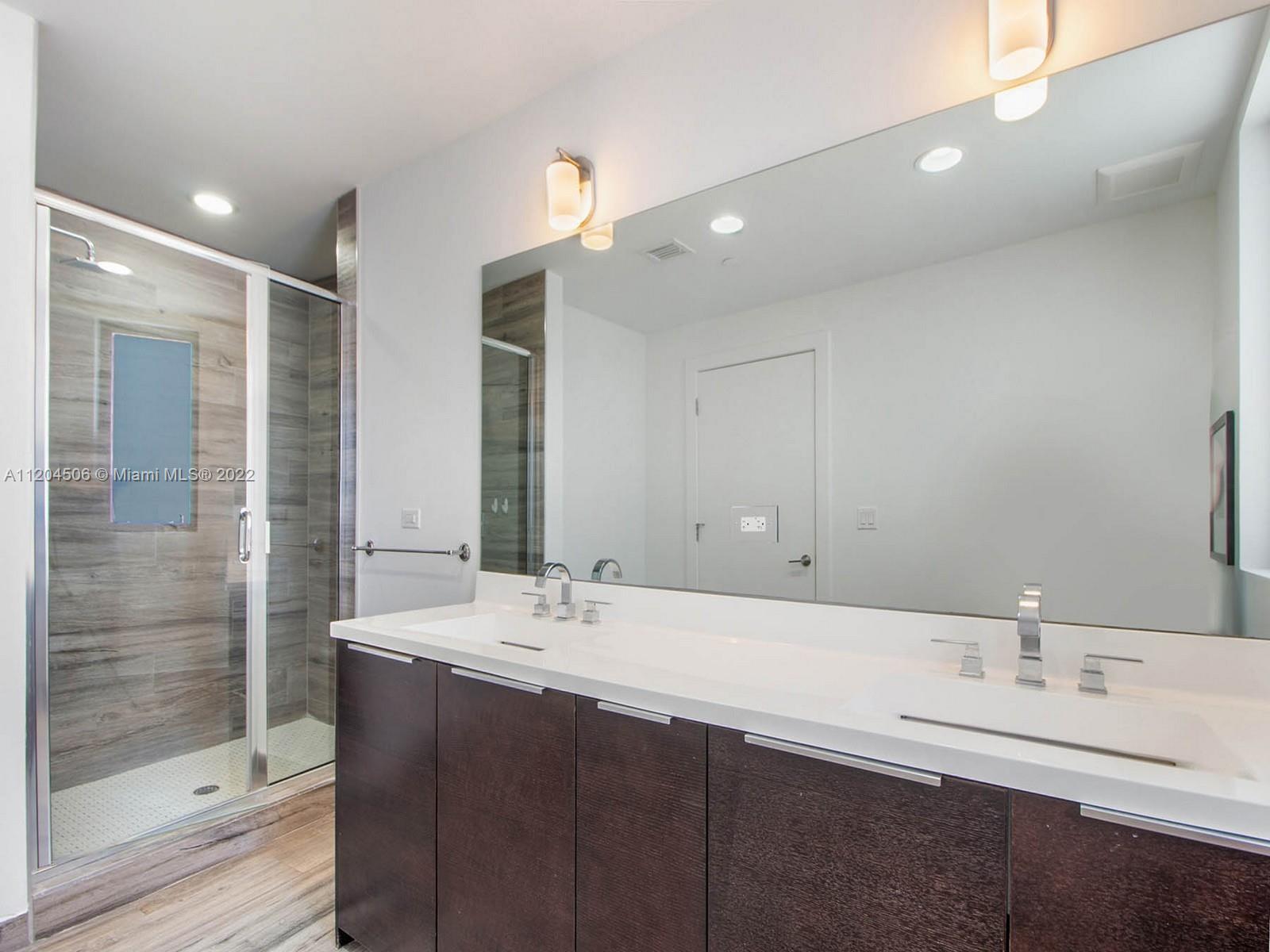 2955 Bird Avenue, Unit PHA Miami, FL 33133 - Photo 18 of 33 a bathroom with a double vanity sink mirror and shower